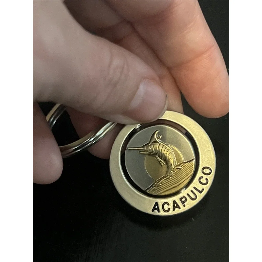 round metal Acapulco‎ souvenir keychain featuring a sailfish design